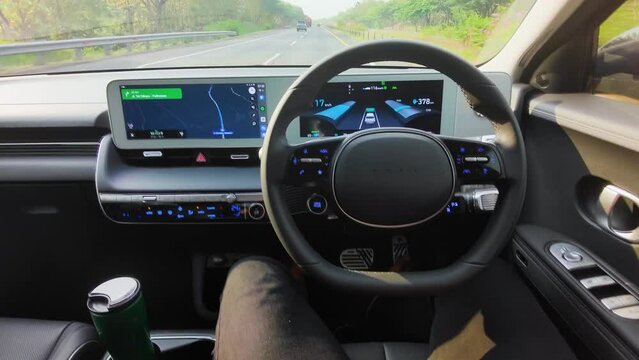Young man driving Hyundai car with autopilot mode