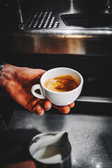 Barista hand making cappuccino Coffee with espresso and milk in cafe