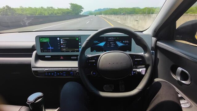 Man sitting on Hyundai car with autopilot mode