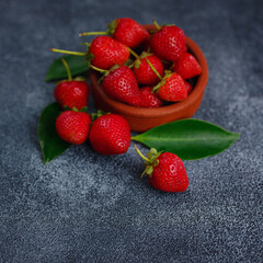 Fresh organic strawberries , over dark background. Vegetarian healthy food concept.