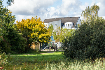 autumn landascape in the park with house in the background