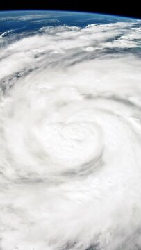 Hurricane eye rotating clouds view from space on planet earth. Vertical video animation for social media based on image by Nasa