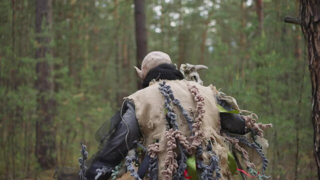animator in monster costume runs away in forest, children's camp