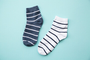 Odd socks day concept. Mismatch socks at color background. Top view.