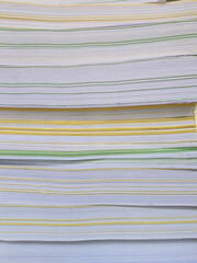 Stacks of white A4 size paper placed on top of each other with yellow and green paper separated by the desired distance. Prepare a blank white sheet of paper to prepare for printing.
