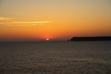 Naklejka na ściany i meble mystical sunset by the sea with a section of coast 