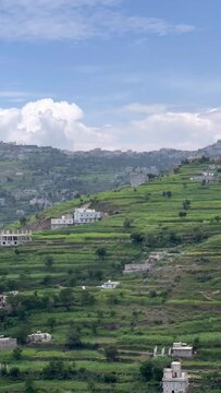 View of city of Ibb in Yemen with agricultural terraces on mountainside in summer. Tourism in Yemen