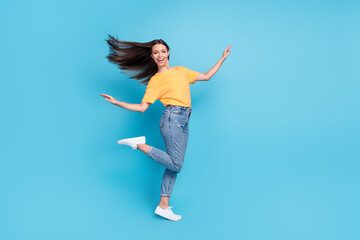 Full length photo of pretty shiny lady wear yellow t-shirt having fun empty space isolated blue color background