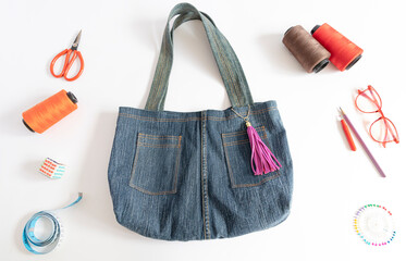 Denim bag with sewing accessories. top view, crafting with denim , recycling concept