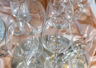 Glasses on a tray. Wine and vodka glasses. Preparation for toasts.