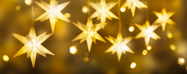 many christmas stars for shiny decoration and festive atmosphere, fairy lights on greeting card...