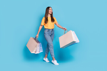 Photo of cheerful lady trendy clothes outfit hold bags enjoy shopping buy new collection look empty...