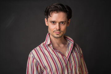 Studio portrait of handsome man against gray background