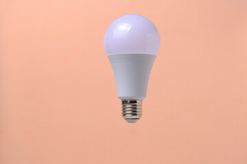 LED eco light bulb on beige background.