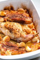 baked rabbit leg with garlic and bacon