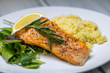 grilled salmon served with couscous and vegetables salad