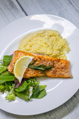 grilled salmon served with couscous and vegetables salad