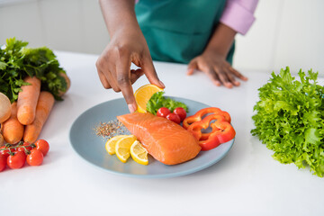 Cropped photo of woman hand hold squeeze fresh lemon juice salmon meat steak kitchen house indoors