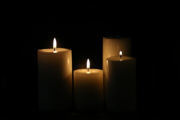 lighted candles on a black background