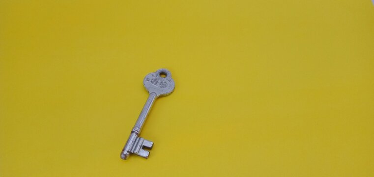Nganjuk, Indonesia - October 16, 2022 : old door lock isolated on yellow background