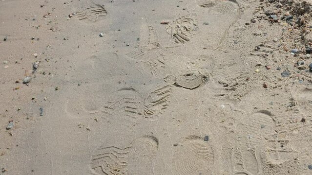 The shoe prints on the sand on the shore of the beach  in Estonia