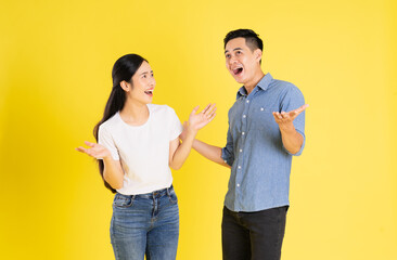 image of asian couple posing on yellow background