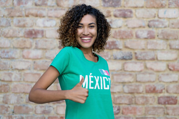 Mexican female football fan showing thumb up