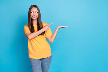 Photo of cute girlish lovely woman straight hairdo yellow t-shirt demonstrating promo look empty...