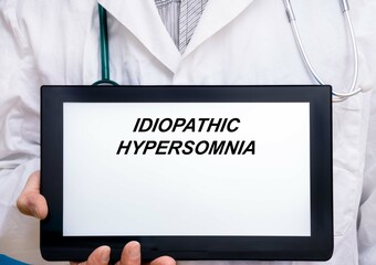 Idiopathic Hypersomnia.  Doctor with rare or orphan disease text on tablet screen Idiopathic...