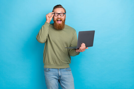 Photo portrait of handsome young guy specs netbook facebook twitter Instagram telegram wear khaki clothes isolated on cyan color background