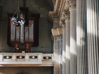 Pipe organ and stone columns with carvings in a church