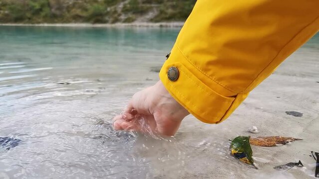 Scoope up a handful of crystal water of ’Blue Moon Valley' beneath Jade Dragon Snow Moutain and Yulong Glacier Yunnan China玉龙雪山蓝月谷
