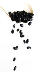 Black bean falling from the spoon.