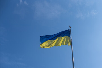 National flag of Ukraine against blue sky