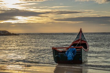 Fishing boats floating on water, twilight sea and beautiful clouds at sunset at Lampuuk beach, Aceh, Indonesia