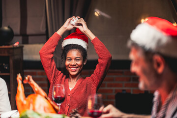 A young girl is smiling at the camera while celebrating christmas with her family.