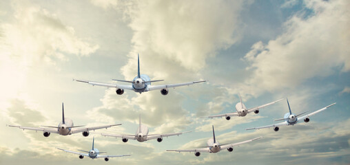 Airplanes flying in sky clouds at sunny day. Landscape with passenger airplane and blue sky
