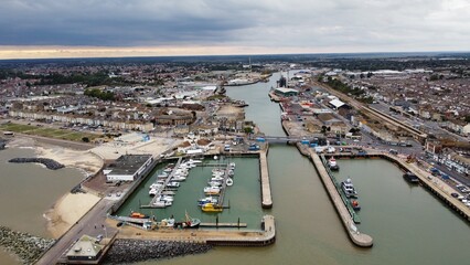 Fototapeta na wymiar Aerial view of Lowestoft harbour and port with boats docked and far reaching views. Lowestoft England. 