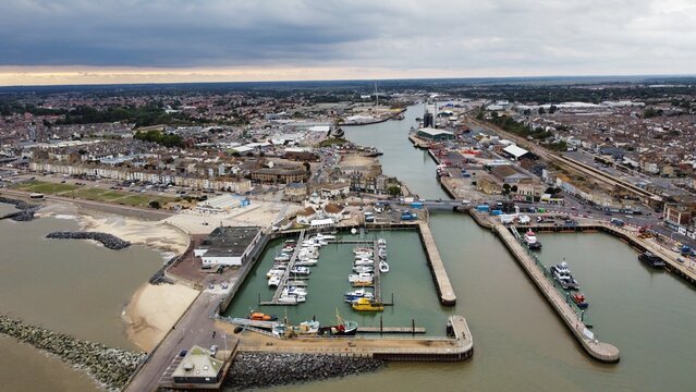 Aerial view of Lowestoft harbour and port with boats docked and far reaching views. Lowestoft England. 