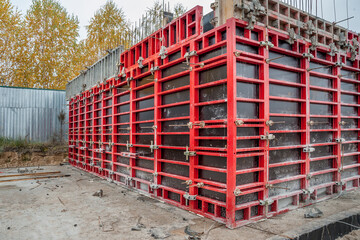 Formwork panels connected by clamps at the construction of an elevator shaft.