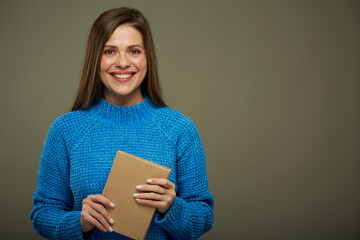 Student or teacher woman with book wearing warm winter clothes. isolated female portrait.
