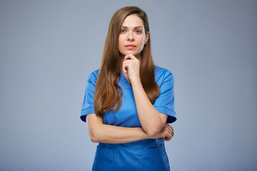 Serious thinking nurse woman in blue medical uniform. Isolated female portrait.