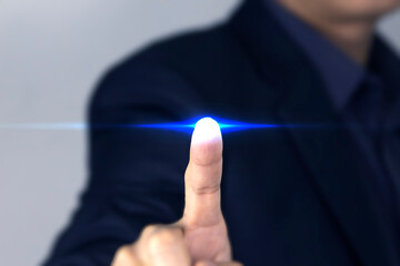 A Businessman finger touching technology blue Light, A smart businessman clicking a blue flare effect of virtual screen, used in business and technology design