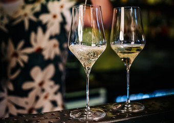bartender pouring white wine into a glass in cafe or bar
