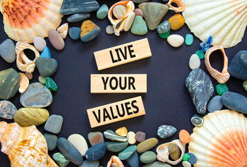 Live your values symbol. Concept words Live your values on wooden blocks. Sea stone, seashell....
