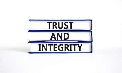 Trust and integrity symbol. Concept words Trust and integrity on books. Beautiful white table white...