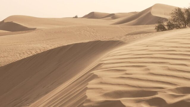 Sand blowing over a dune in the desert