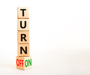 Turn on or off symbol. Concept words Turn off and Turn on on wooden cubes. Beautiful white table white background. Business Turn on or off concept. Copy space.