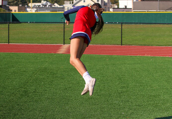 Cheerleader twisting in the air