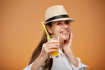 Smiling  beautiful woman holding orange juicy drink. Isolated female advertising portrait.